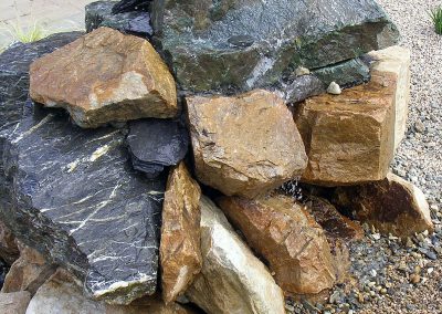 Burbling water feature using core drilled rock.