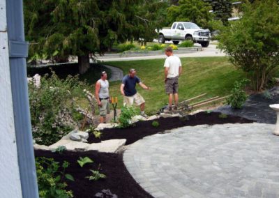 Circle patio with garden & steps behind.