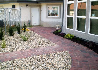 Network of paths, surrounded by planter areas & ornaments (rock).