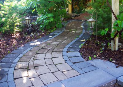 Rustic walkway, growing moss in the cracks.