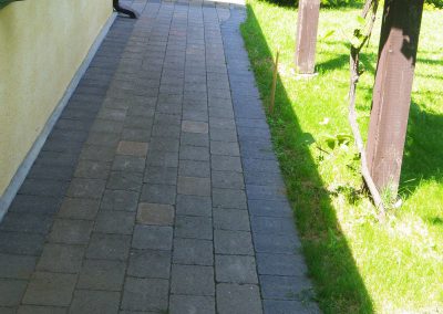 Straight walkway for access down side of house.